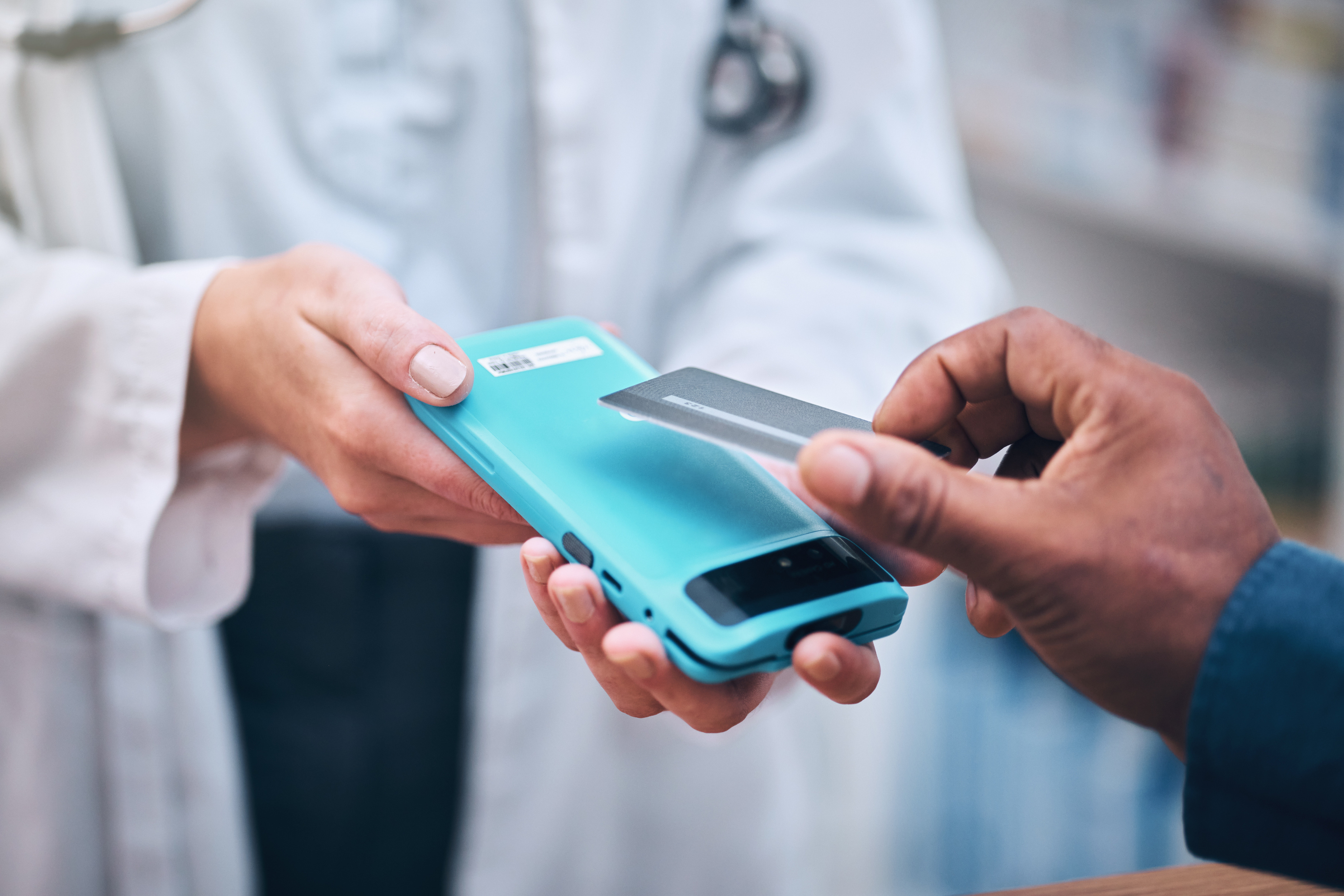 A person making a cashless payment with a credit card on a mobile terminal